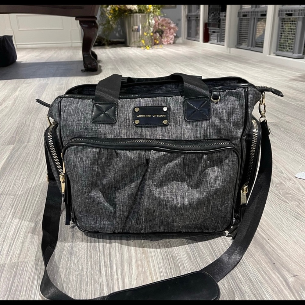 Adrienne Vittadini overnight bag with 4 compartments outside and 4 in.Big zipper